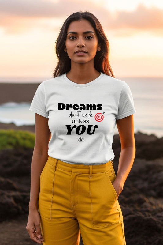 ZUPPI women's white graphic t-shirt with 'Dreams don't work unless you do' quote, worn by a model in an outdoor scene.