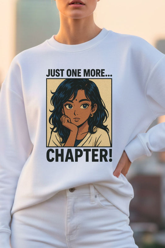 White oversized sweatshirt with an illustration of a woman and text 'Just one more... Chapter!' worn by a woman.