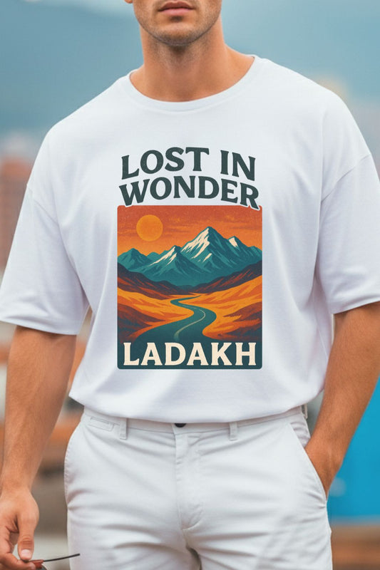 close up of a man wearing a white oversized t-shirt with 'Lost in Wonder Ladakh' design.