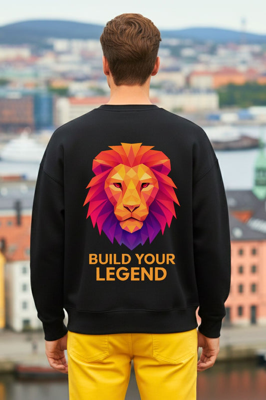 back view of a person wearing a black oversized sweatshirt with a colorful lion graphic and 'Build Your Legend' text, standing against an urban landscape.