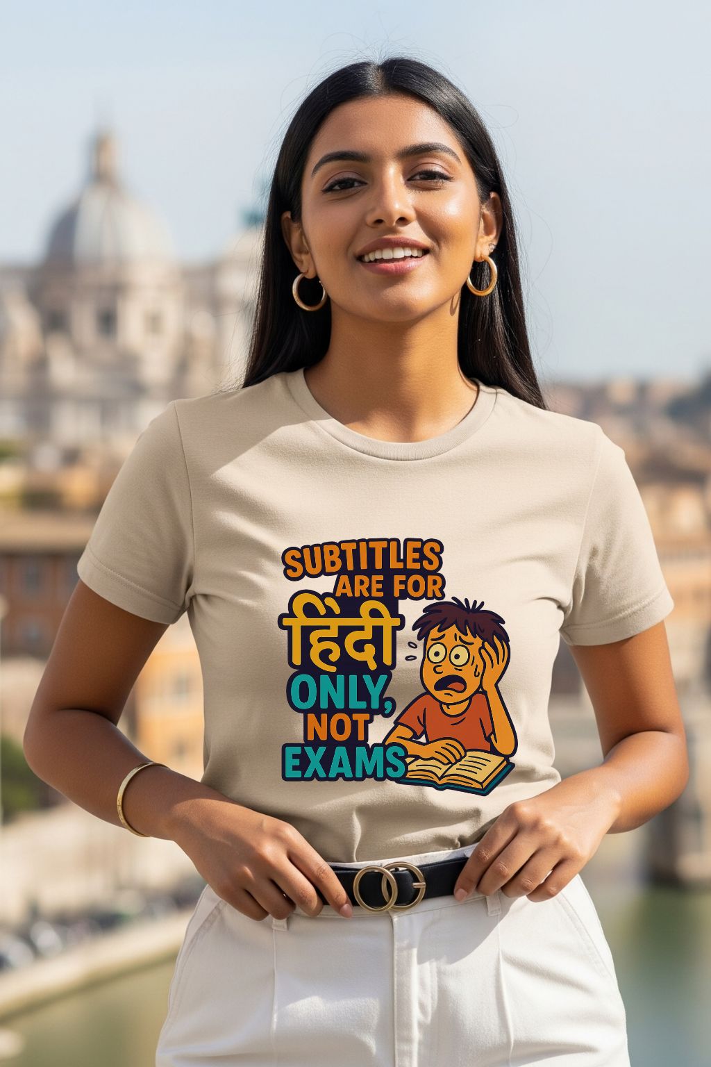 Woman wearing a t-shirt with a graphic design and text, standing outdoors with a blurred cityscape in the background.