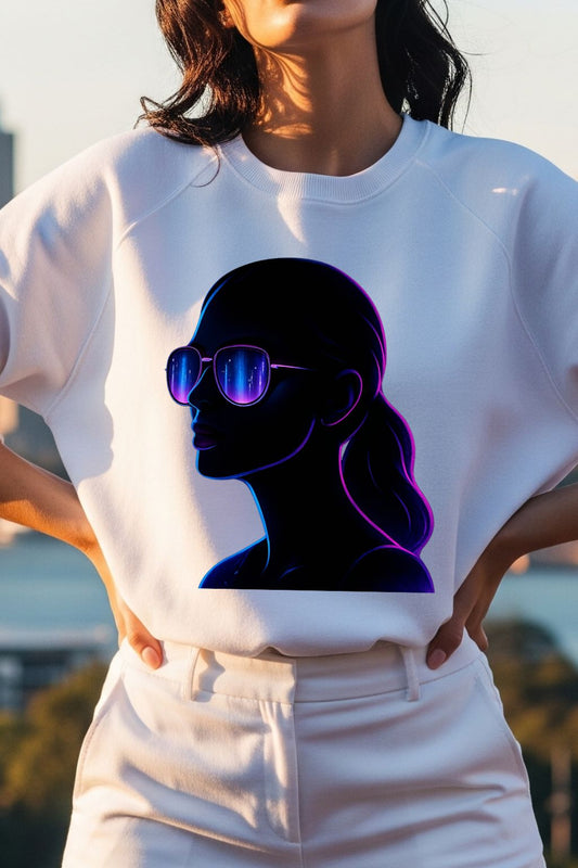Person wearing a white t-shirt with a black silhouette of a person with sunglasses design.