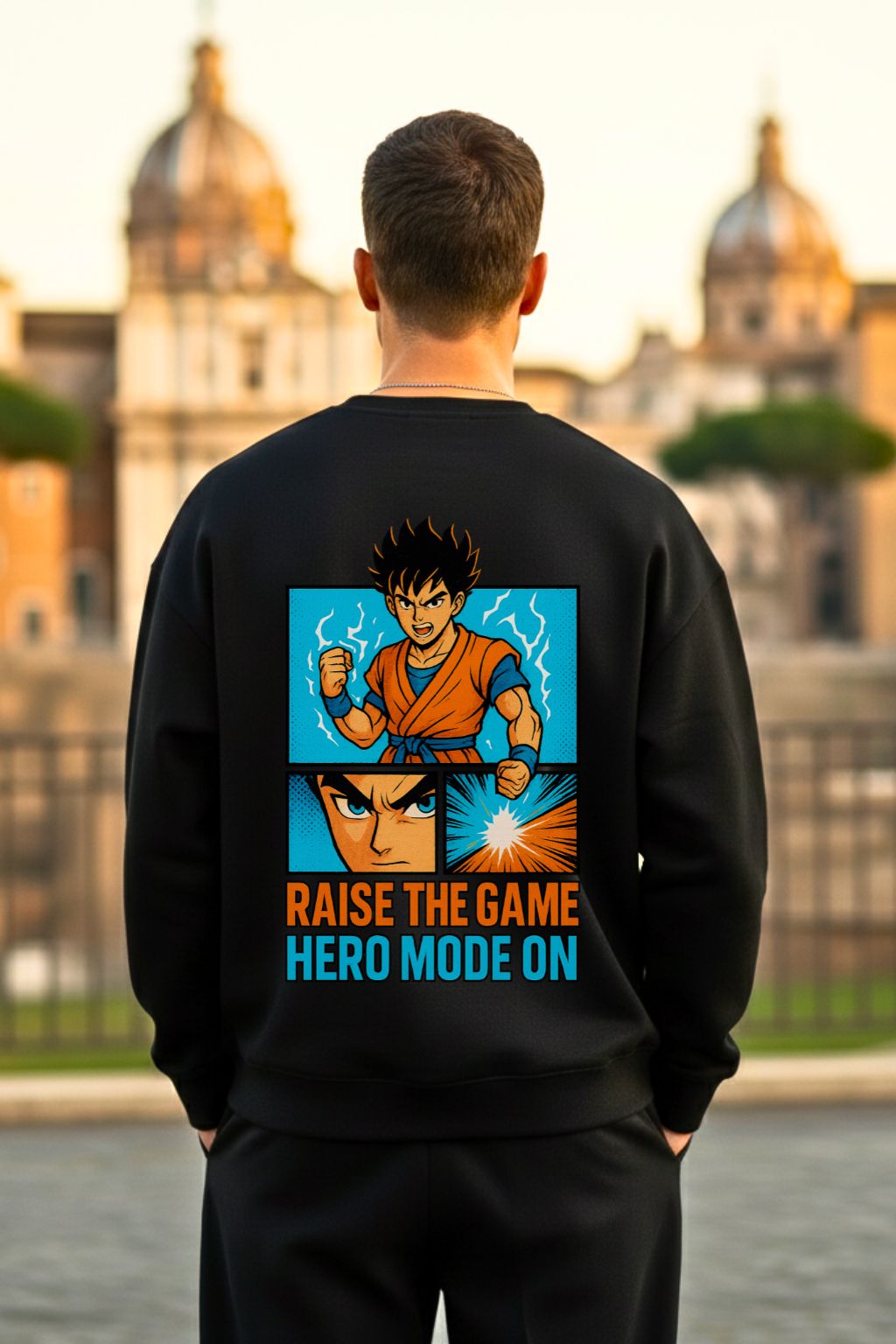 Back view of a man wearing a black oversized sweatshirt with anime-themed design and text, standing in front of a cityscape.