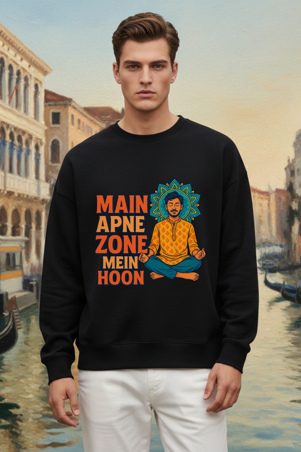 Man wearing a black oversized  sweatshirt with a colorful graphic and text, standing in front of a scenic background.