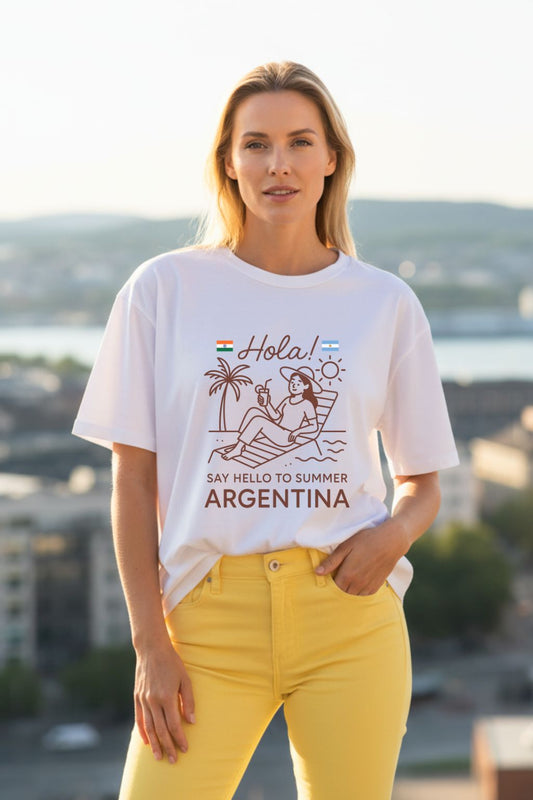 Woman wearing a white t-shirt with a graphic design and text, standing outdoors.