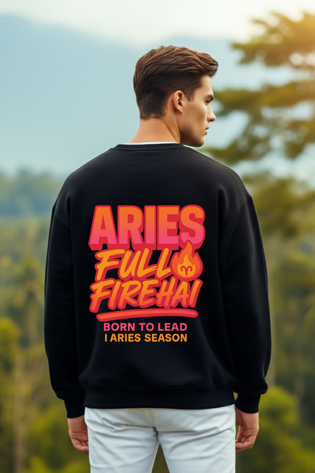 Man wearing a black sweatshirt with 'ARIES FULL FIREHAI' text in pink and orange, standing outdoors.