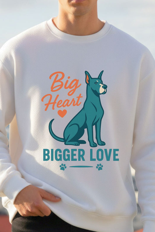 Man wearing a white sweatshirt with a dog graphic and text 'Big Heart, Bigger Love' on a blurred outdoor background.