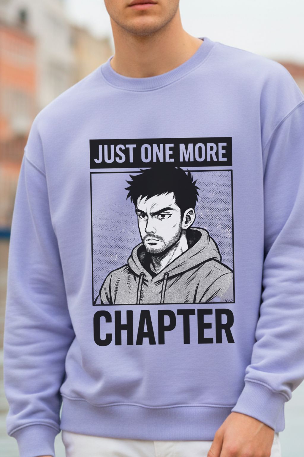 close up of a lavendar oversized  sweatshirt with graphic design and text 'Just One More Chapter' worn by a man.