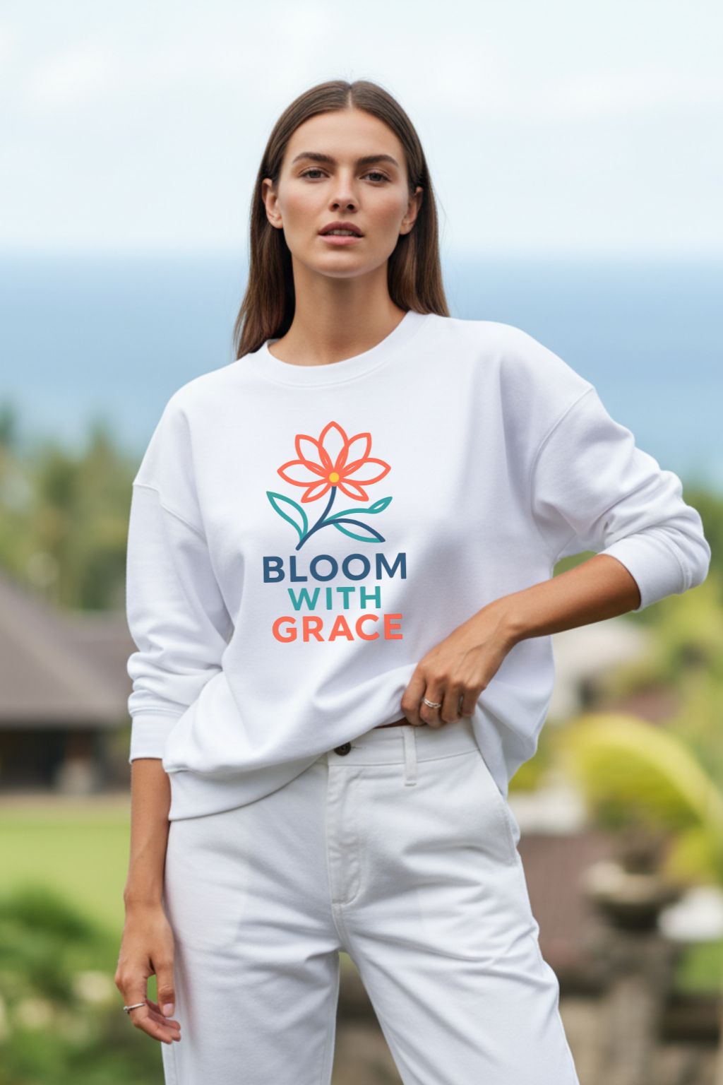 Woman wearing a white oversized sweatshirt with 'Bloom with Grace' logo outdoors
