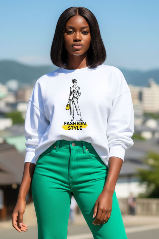Woman wearing a white oversized sweatshirt with a fashion design and green pants outdoors.