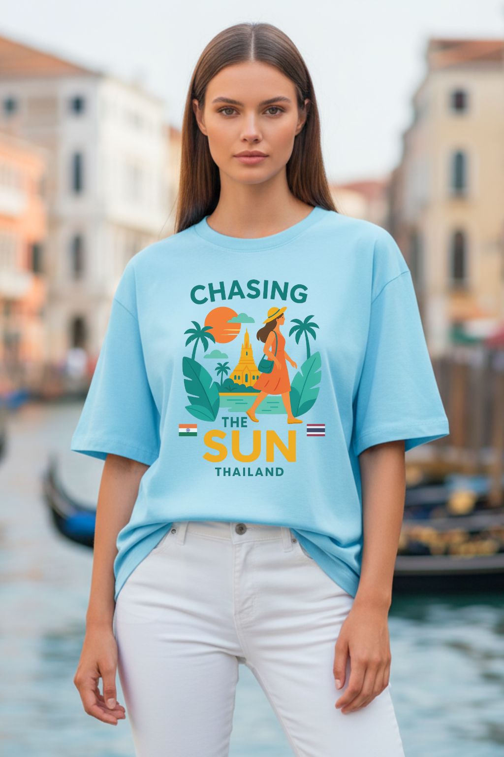 Woman wearing a baby blue oversized t-shirt with a colorful graphic design in an urban setting.