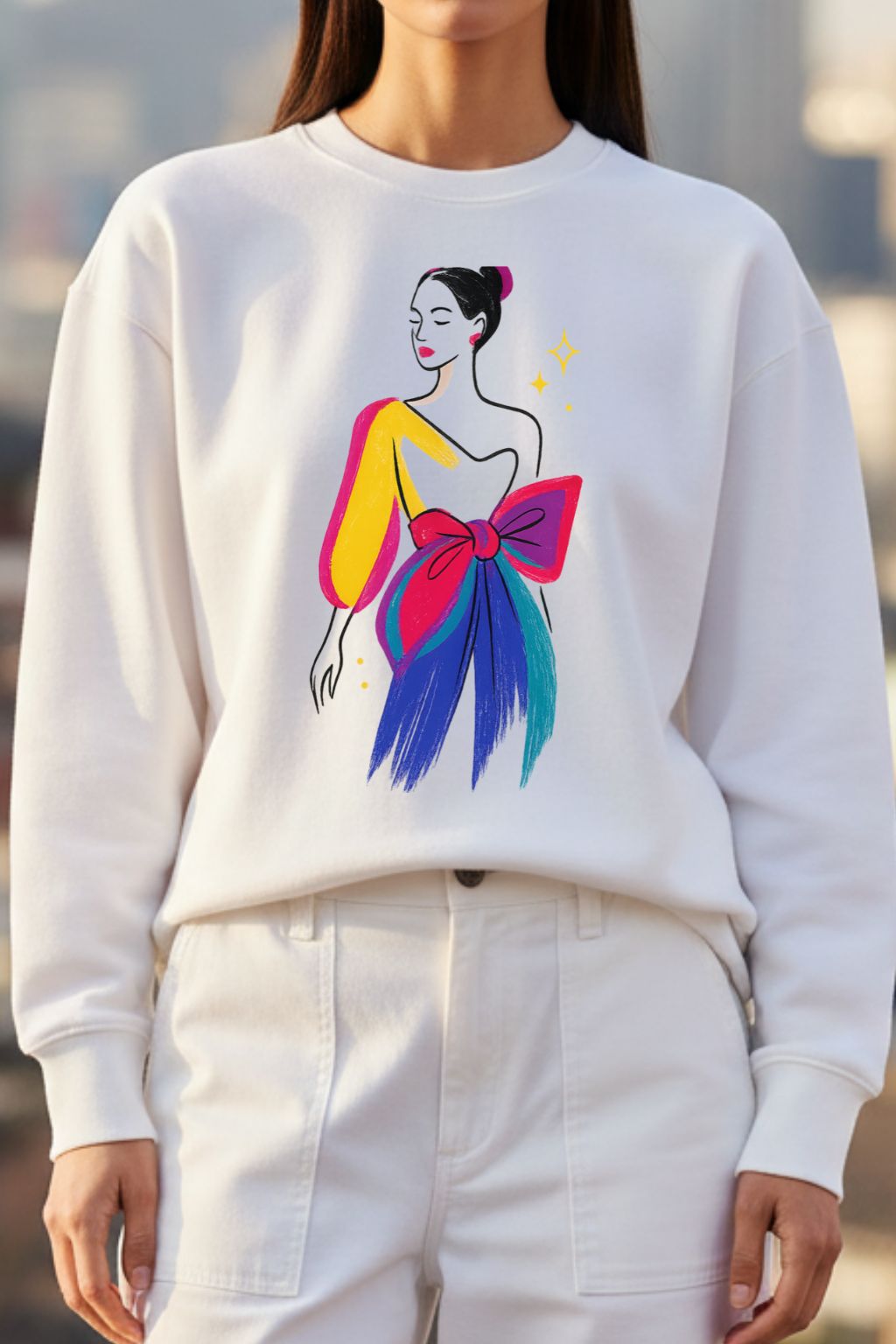 Woman wearing a white sweatshirt with a colorful graphic design of a woman with a large bow.