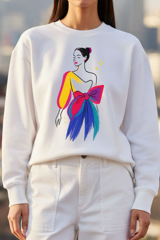 Woman wearing a white sweatshirt with a colorful graphic design of a woman with a large bow.