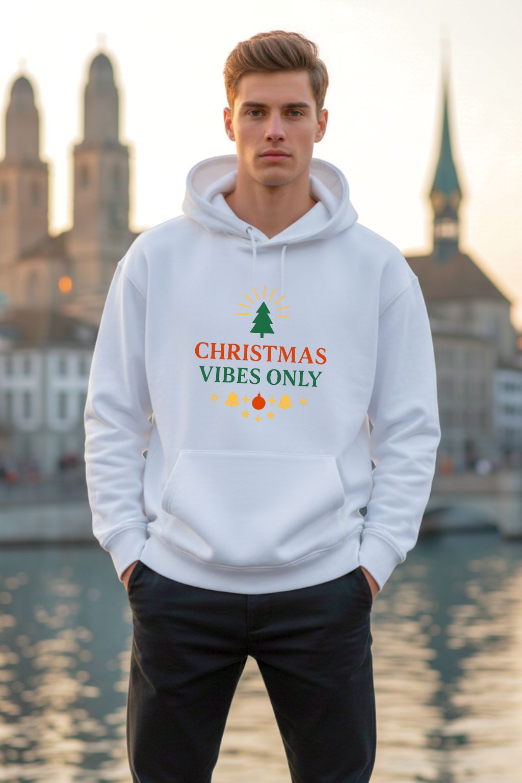 Man wearing a white hoodie with 'Christmas Vibes Only' text in an urban setting