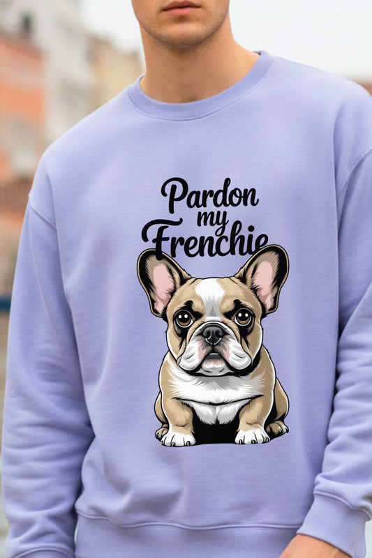 close up of a man wearing a lavendar oversized sweatshirt with a cartoon French bulldog and text 'Pardon my Frenchie'.