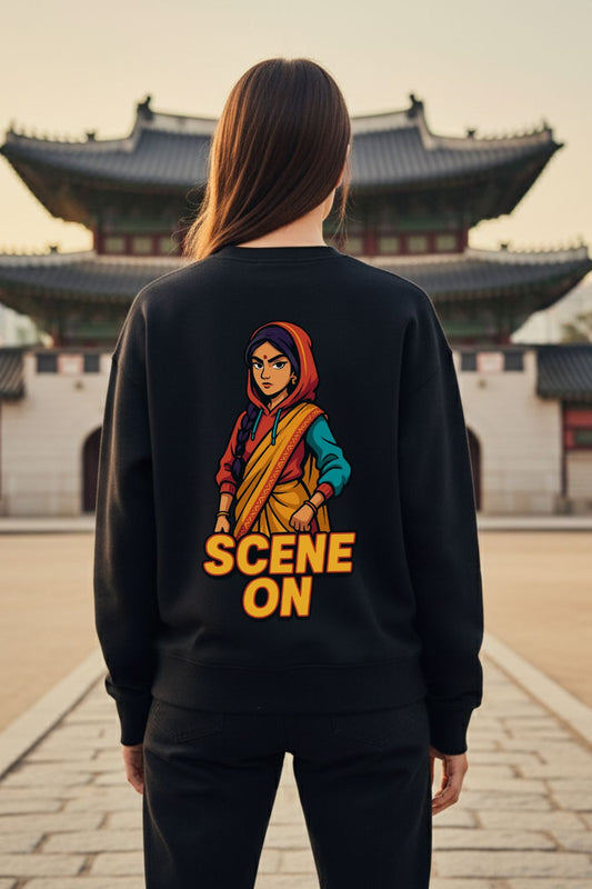 Woman wearing a black sweatshirt with a graphic design and text 'SCENE ON' in front of traditional architecture.