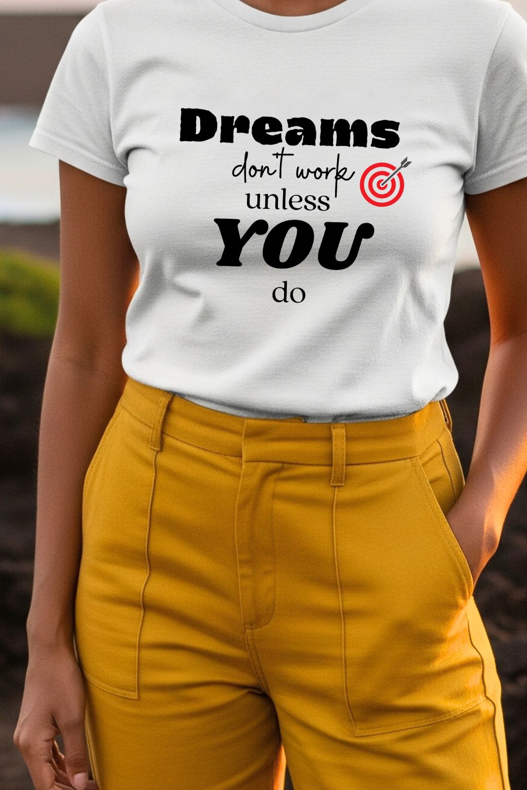 ZUPPI women's white t-shirt with a closer look at the 'Dreams don't work unless you do' quote, styled with mustard yellow pants.