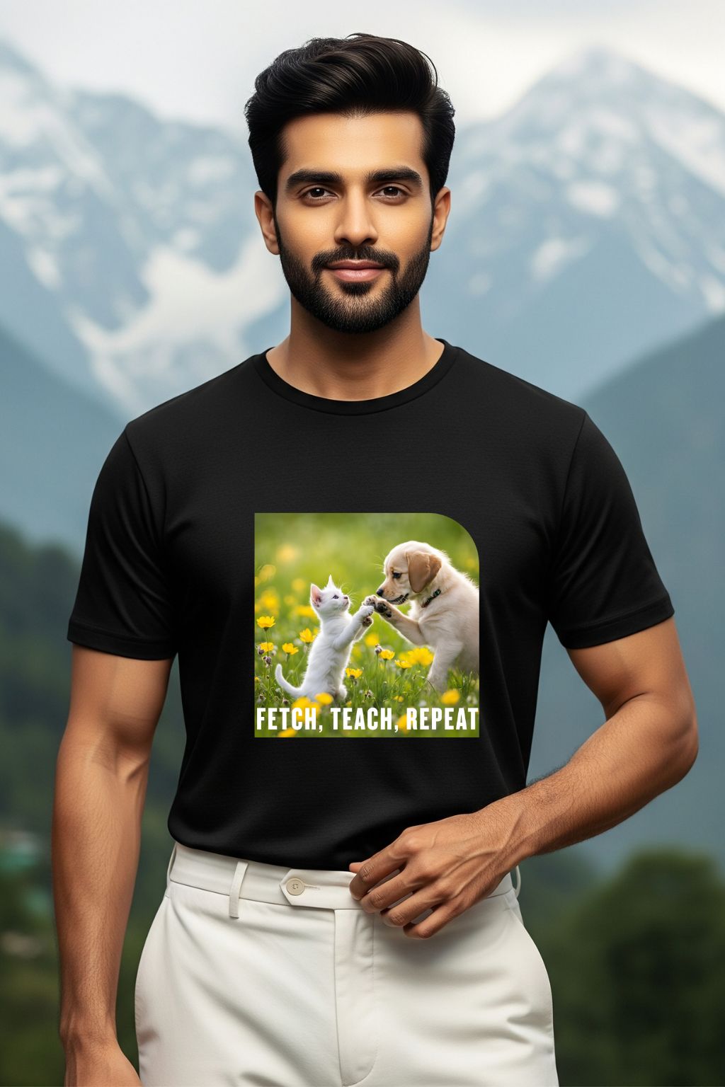 ZUPPI's "Fetch, Teach, Repeat" black t-shirt, featuring a graphic of a dog and a cat, worn by a man against a mountainous background.