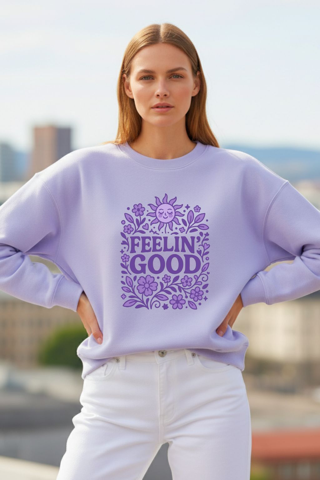 Woman wearing a lavender oversized sweatshirt with 'FEELIN GOOD' text and floral design outdoors.