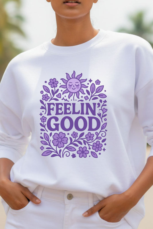 close up of a woman wearing a white oversized sweatshirt with purple floral design and 'FEELIN' GOOD' text.