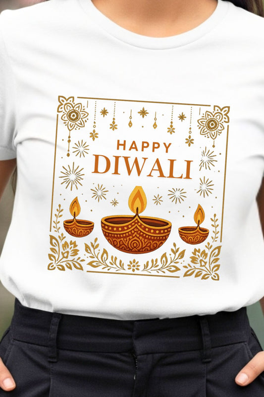 Close-up of a white men's t-shirt featuring a detailed graphic print for Diwali, the festival of lights. The design shows multiple lit clay diyas surrounded by vibrant, traditional Indian rangoli art.