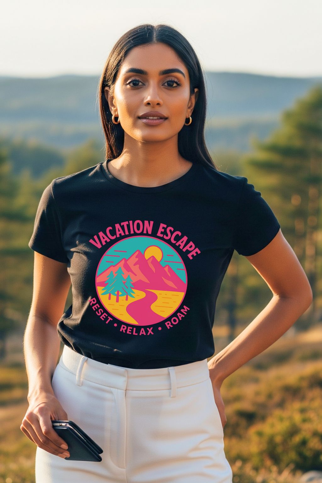 Woman wearing a black t-shirt with a colorful graphic design outdoors