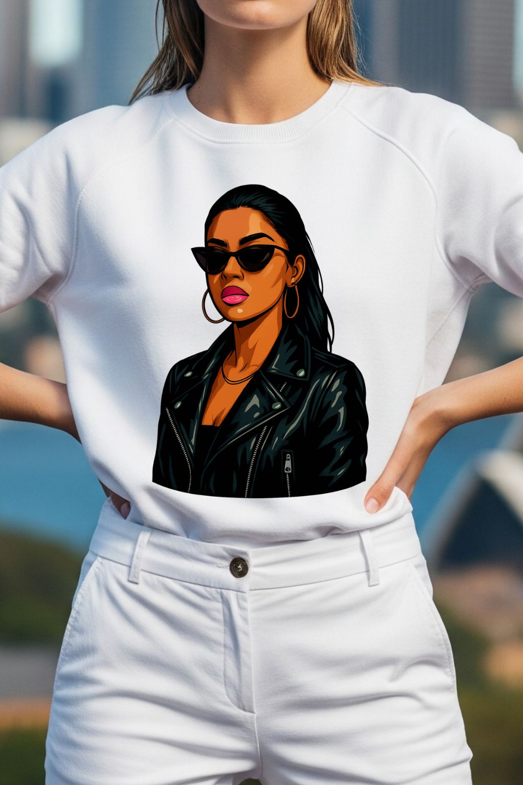 Woman wearing a white t-shirt with a graphic of a woman in sunglasses and a leather jacket.
