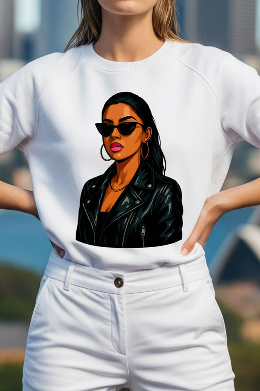 Woman wearing a white t-shirt with a graphic of a woman in sunglasses and a leather jacket.
