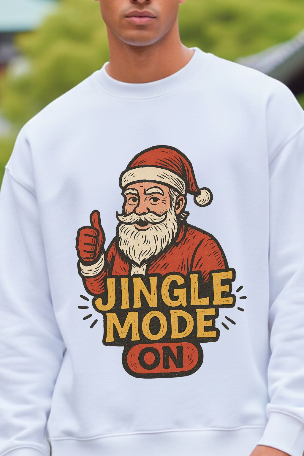 close up of a white oversized sweatshirt with a graphic of Santa Claus giving a thumbs up and 'Jingle Mode On' text.