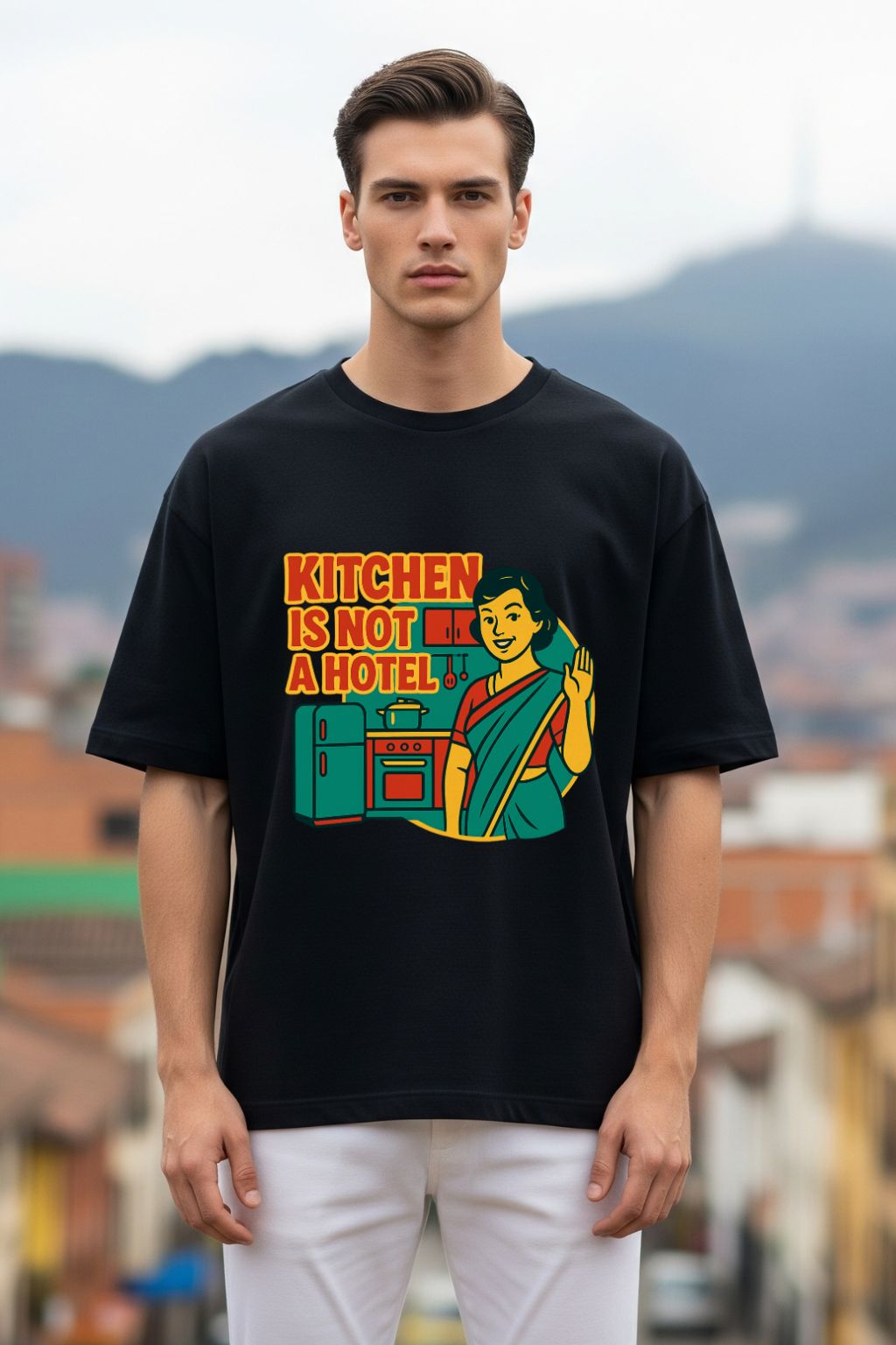 Man wearing a black t-shirt with a colorful graphic and text, standing outdoors.