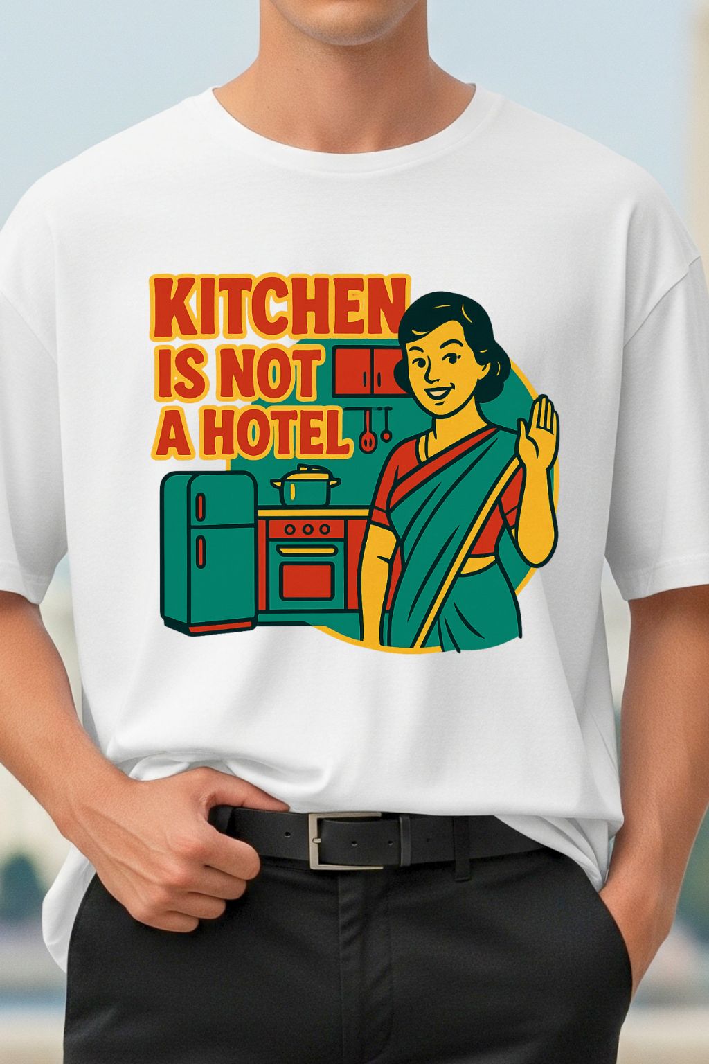 Person wearing a white t-shirt with a colorful graphic and text 'Kitchen is not a hotel'.