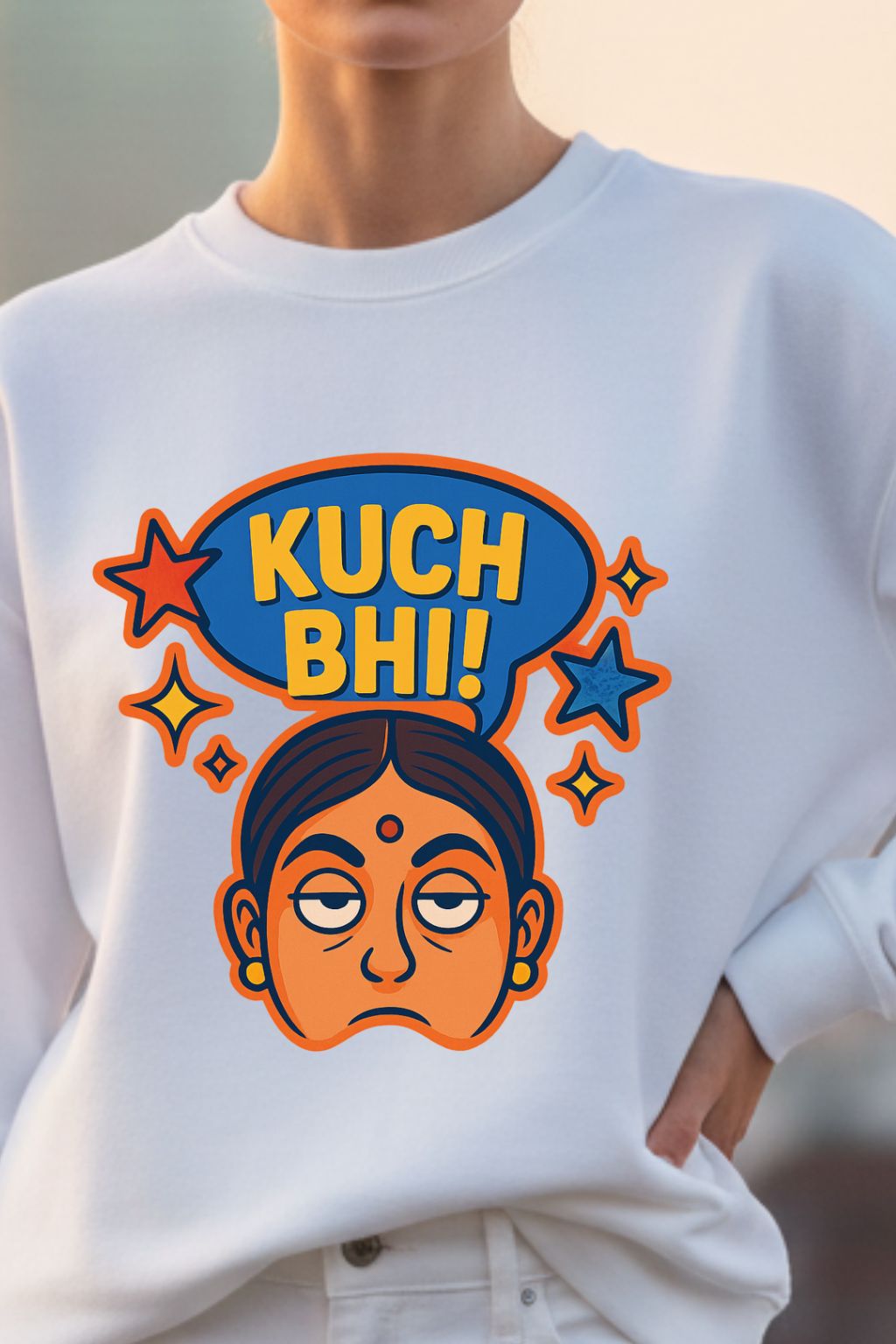 White sweatshirt with colorful graphic design of "Kuch Bhi" featuring text and a face.
