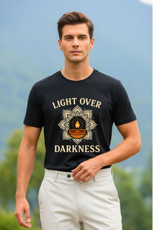Black graphic t-shirt featuring the inspirational phrase 'Light Over Darkness' in a unique font. A perfect choice for motivational and modern spiritual wear, inspired by a powerful message.