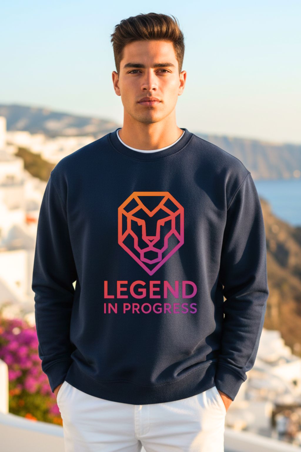 front view of a man wearing a navy oversized sweatshirt with a pink and orange graphic and text 'LEGEND IN PROGRESS' outdoors.