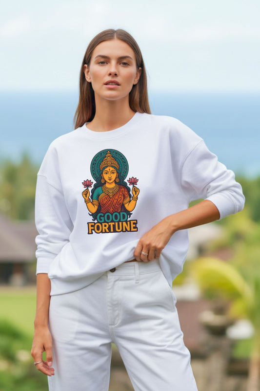 front view of a Woman wearing a white oversized sweatshirt with a 'Good Fortune' design outdoors.