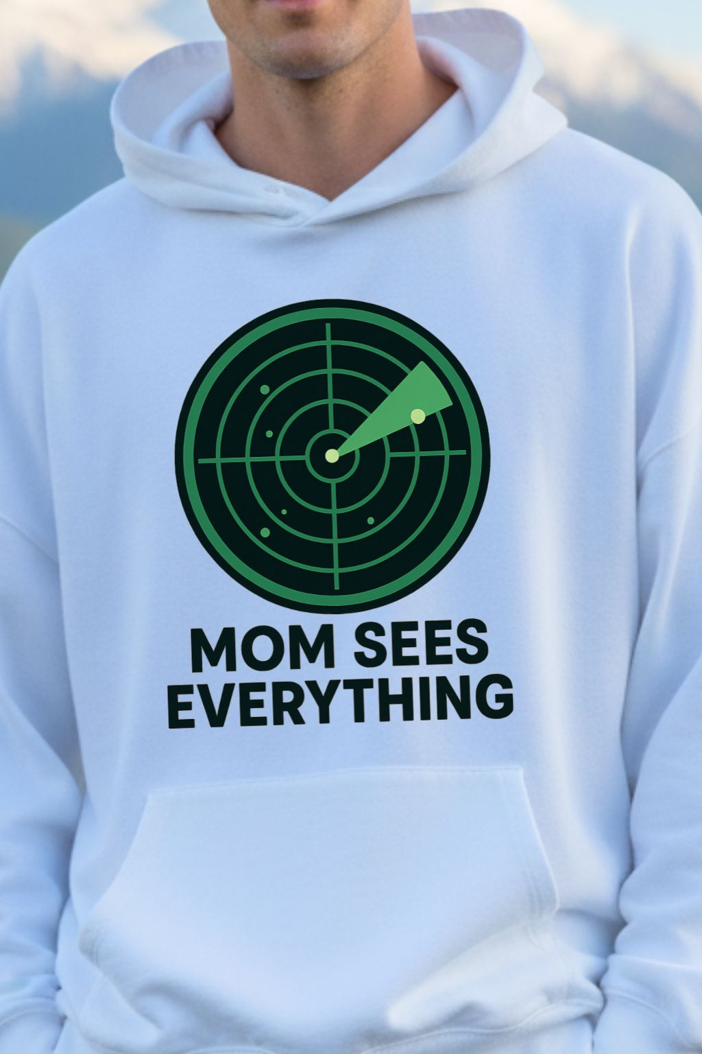White hoodie with a green and black graphic and text 'Mom Sees Everything' on a plain background
