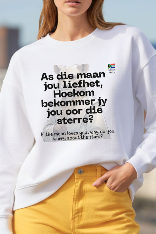 close up view of a woman wearing a white oversized sweatshirt with a printed design and text.