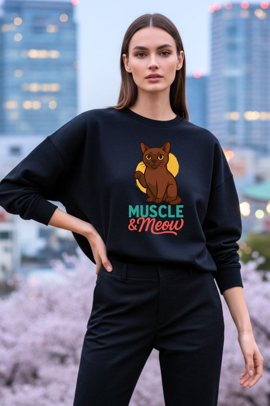 Woman wearing a black oversized sweatshirt with a cat graphic and text in an urban setting