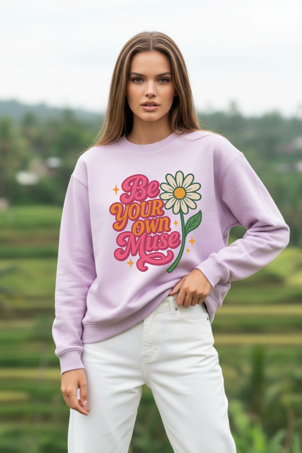 Woman wearing a lavender oversized sweatshirt with a floral graphic and text, standing outdoors.