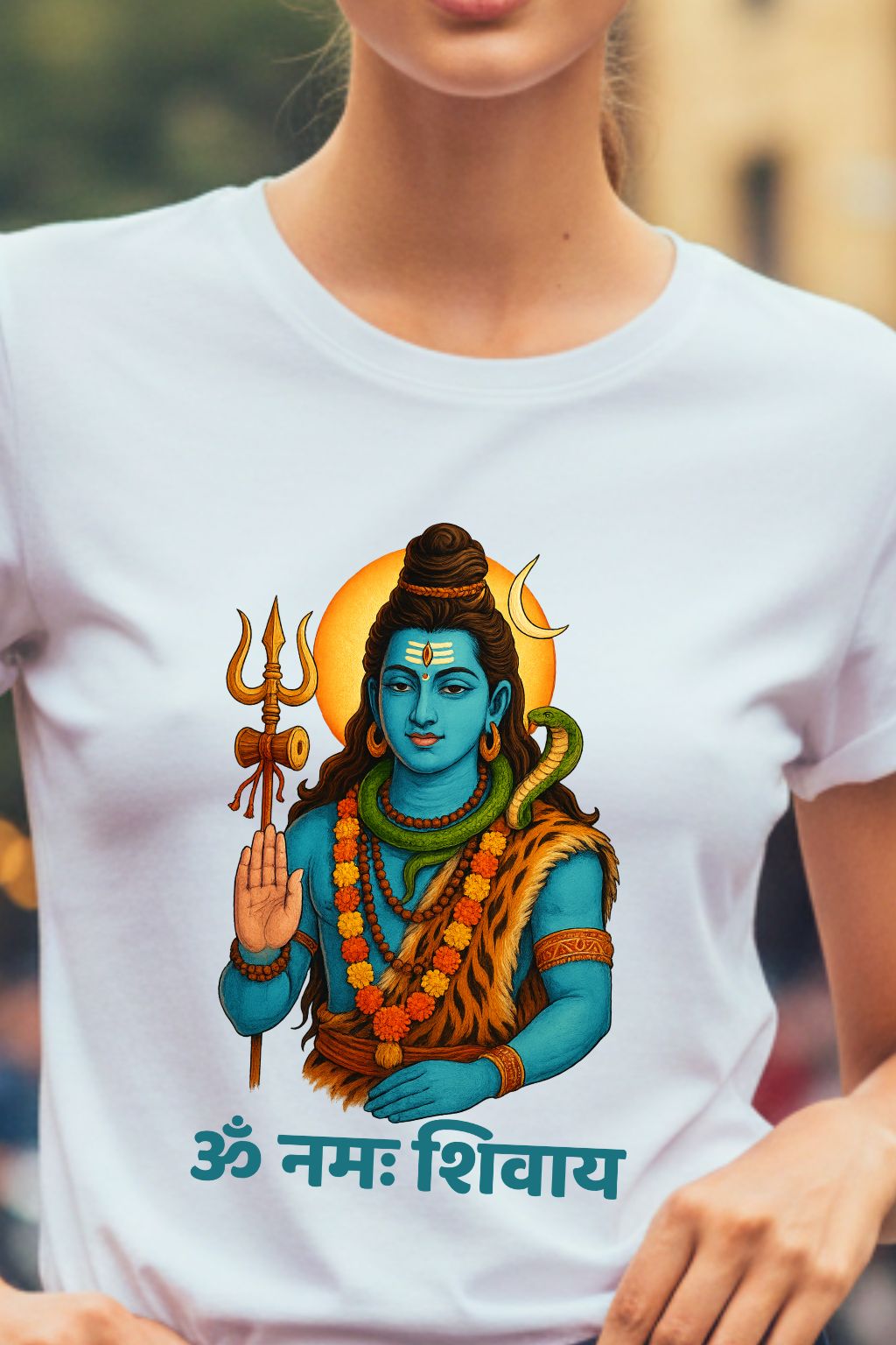 Woman wearing a white t-shirt with a colorful graphic of Lord Shiva and text.