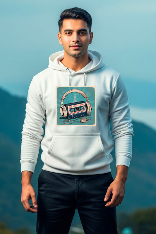 A young man in a relaxed pose wears a white hoodie with an "Old School Jams" graphic design, photographed outdoors with mountains in the background