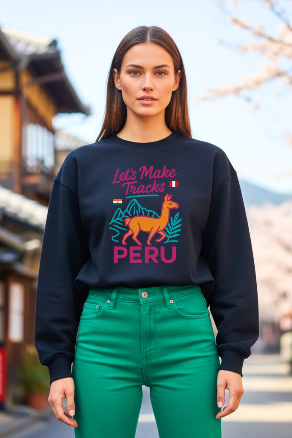 Woman wearing a black sweatshirt with 'Let's Make Tracks Peru' design outdoors.