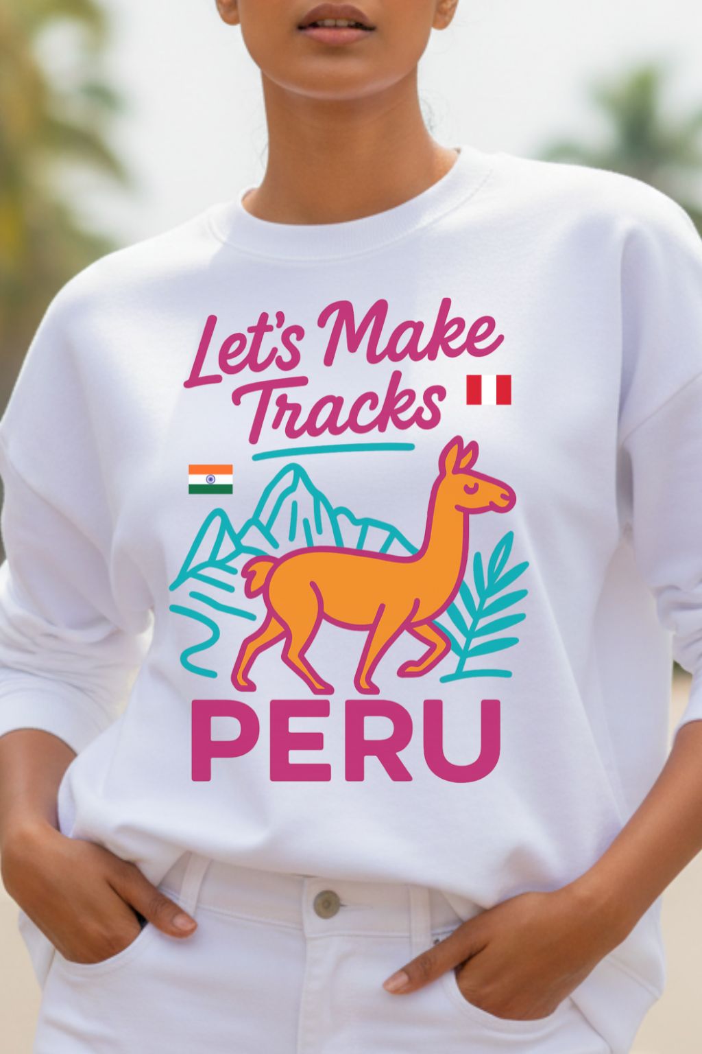 close up of a woman wearing a white sweatshirt with colorful graphic and text 'Let's Make Tracks Peru'.