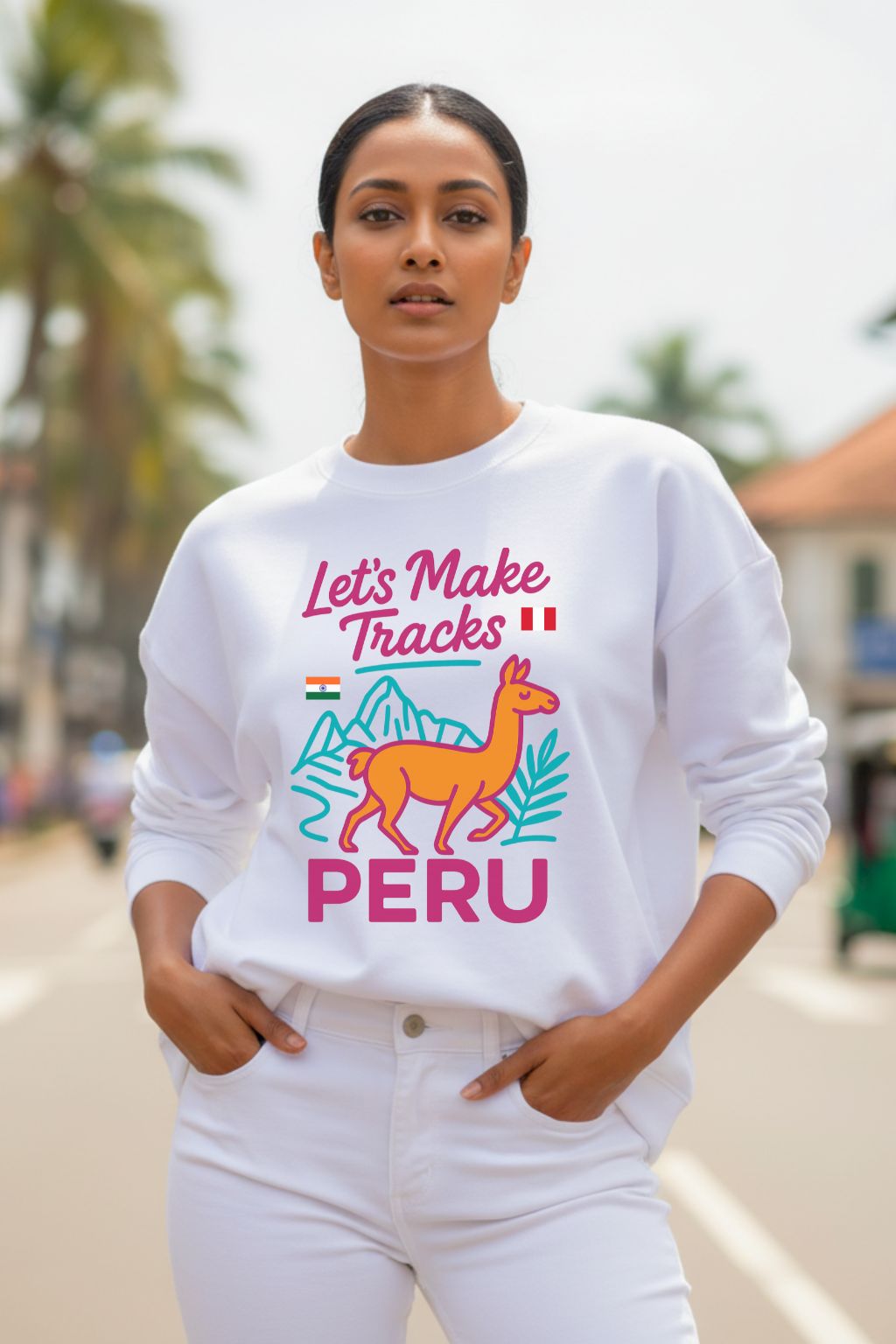 Woman wearing a white sweatshirt with colorful graphics and text, standing outdoors.