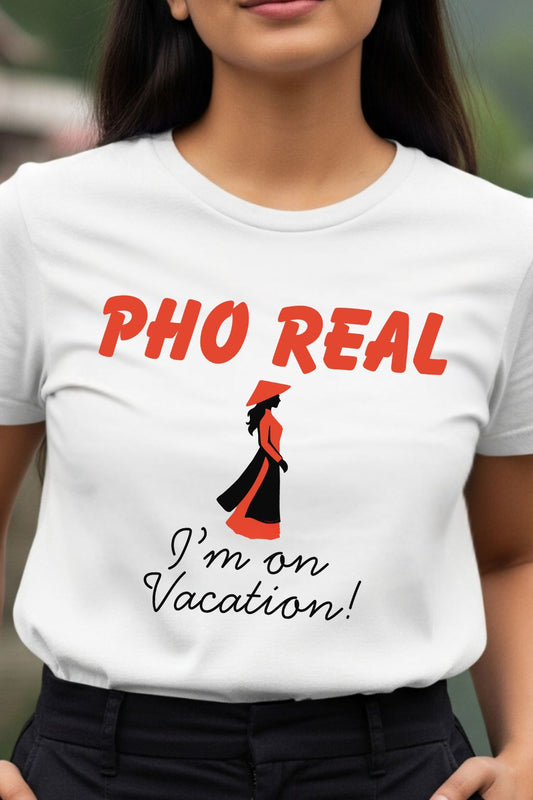 White t-shirt with the design of "Pho real, I am on vacation!" worn by a person.