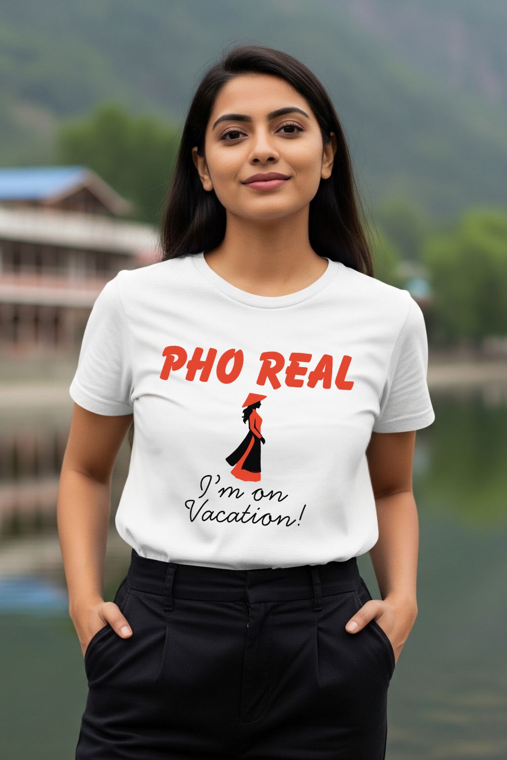 Woman wearing a white t-shirt with 'PHO REAL I'm on Vacation!' text and graphic, standing outdoors.