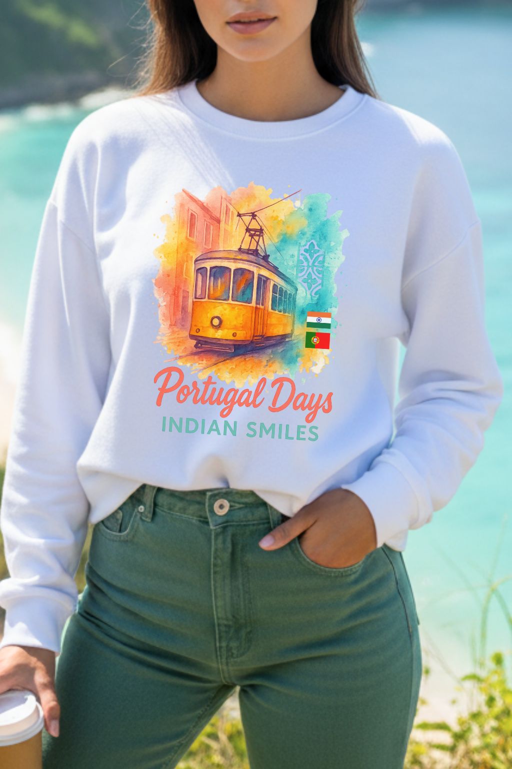 close up of a woman wearing a white oversized sweatshirt with a colorful graphic and text, standing outdoors.