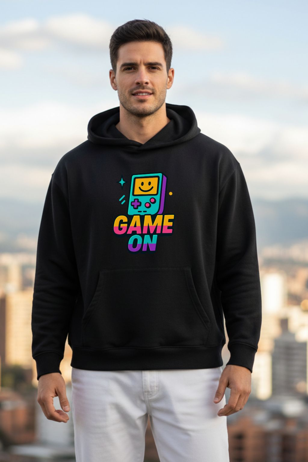 Man wearing a black oversized hoodie with 'Game On' graphic design against a cityscape background