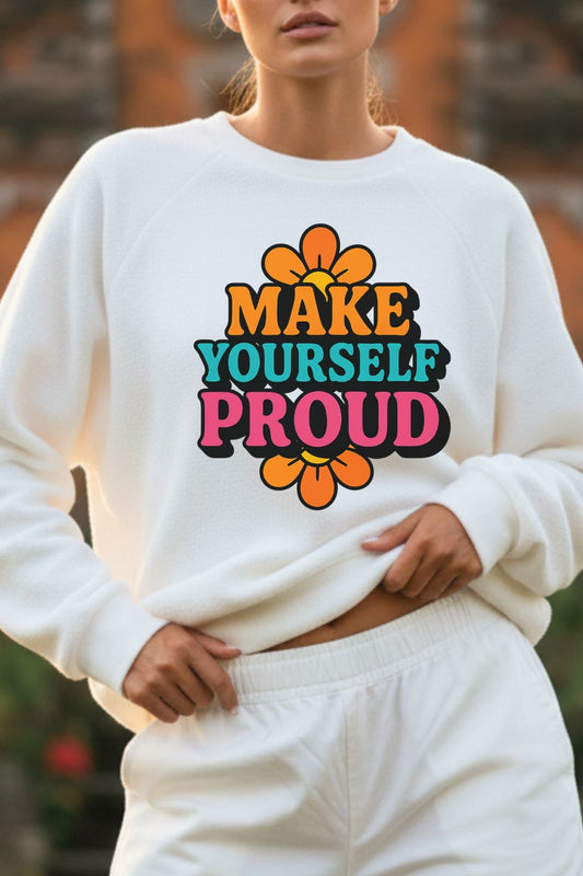 close up of a woman wearing a white oversized sweatshirt with 'MAKE YOURSELF PROUD' text and colorful design.