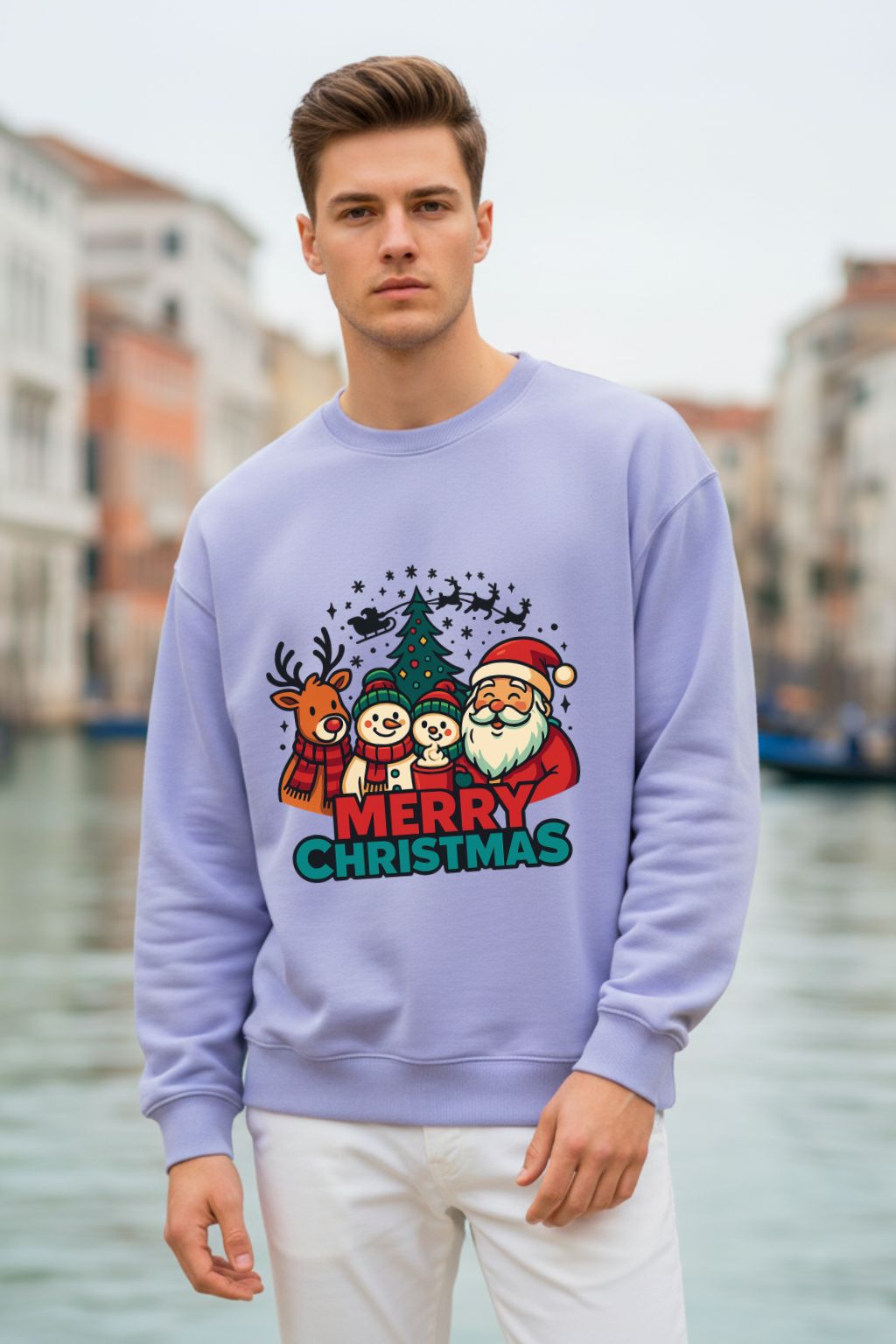 Man wearing a lavendar oversized  sweatshirt with a Christmas design, standing by a waterfront.